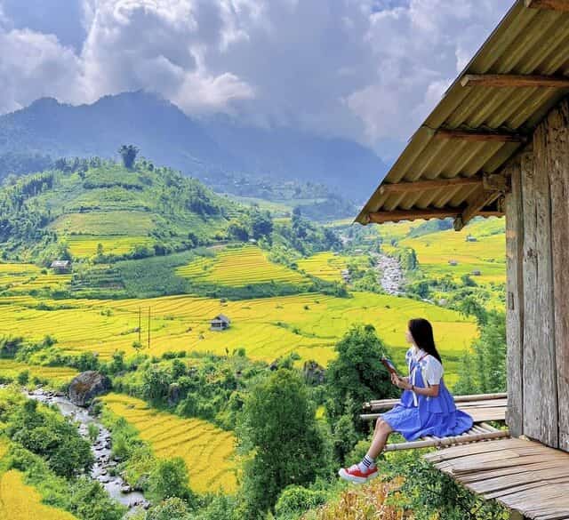 Terraced rice fields nestled in the valley, surrounded by mountains, forests, and sky, creating a beautiful landscape