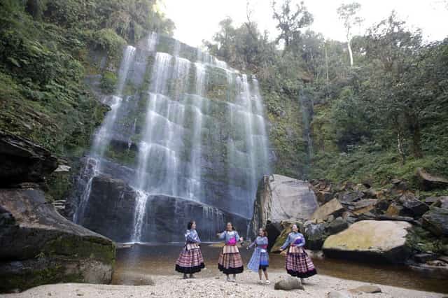 Dao girls playing at the foot of the waterfall