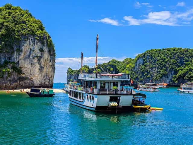 The limestone islands in Lan Ha Bay are all covered with lush green vegetation.