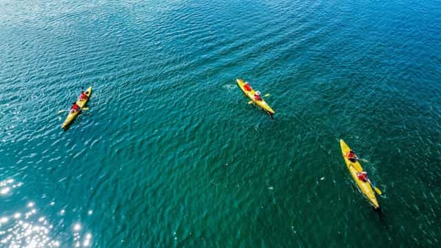 Tourists kayaking to explore Lan Ha Bay.